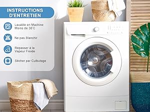 avec instructions d'entretien. Les icônes indiquent un lavage en machine à une température inférieure à 30 °C, sans agent de blanchiment, un séchage au sèche-linge et un fer à repasser. Placé dans la buanderie avec des paniers et des plantes.