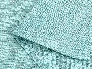 Gros plan d'un tissu texturé vert menthe plié avec un motif de tissage visible, montrant l'épaisseur et la texture du matériau