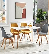 avec table rectangulaire blanche, deux chaises jaune moutarde et deux chaises grises. Impression d'art abstrait sur mur.